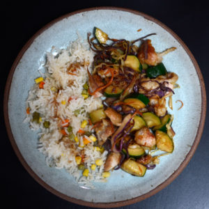 Lightly breaded chicken stir fry with white rice and veggies